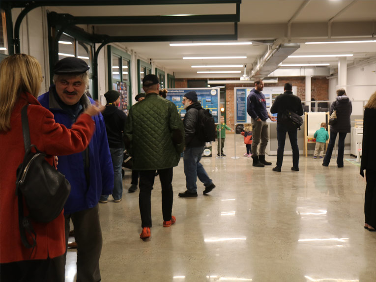 Inside Welcome Center with people gathering and socializing